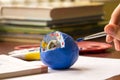 Child learns biology, studies the structure of the cell. Cell is made of clay and painted with tempera Royalty Free Stock Photo