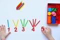 The child learns Number line and geometric shapes. The preschooler works with Montessori material. Educational logic toys for kid Royalty Free Stock Photo