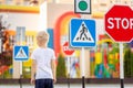 A child learns to cross the road at a pedestrian crossing, traffic rules for children Royalty Free Stock Photo