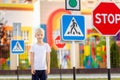 A child learns to cross the road at a pedestrian crossing, traffic rules for children Royalty Free Stock Photo