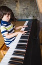 A child learns to play the piano Royalty Free Stock Photo