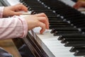 A child learns to play the piano in the lessons at a music school. Royalty Free Stock Photo