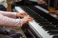 A child learns to play the piano in the lessons at a music school. Royalty Free Stock Photo