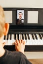 CHILD LEARNS TO PLAY THE PIANO ONLINE Royalty Free Stock Photo