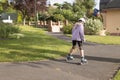 a child learns to roller skate in the park a dressed girl in a lilac sweater Royalty Free Stock Photo