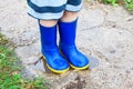 Child legs in blue rubber boots Royalty Free Stock Photo