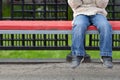 Child legs dangling from bench with copy space