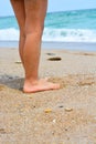 Child legs on sand on a beach