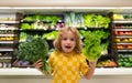 Child with lettuce chard vegetables. Child buying fruit in supermarket. Little boy buy fresh vegetables in grocery store Royalty Free Stock Photo