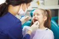 Child lies in dentist chair and goes through procedure