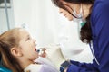 Child lies in dentist chair and goes through procedure