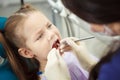 Child lies in dentist chair and goes through procedure