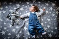 The child lies on a star blanket. Cute newborn baby girl lying in bed. Owl child sleeping on a blue blanket with stars. in Royalty Free Stock Photo