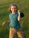 Child lifting the kettlebell in backyard outside. Child workout. Kid sport. Child exercising with kettlebell dumbbells Royalty Free Stock Photo