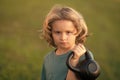 Child lifting the kettlebell in park outside. Child workout. Kid sport. Child exercising with kettlebell dumbbells