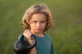 Child lifting the kettlebell in park outside. Child workout. Kid sport. Child exercising with kettlebell dumbbells Royalty Free Stock Photo