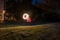 Child light painitng with christmas sparklers outside.