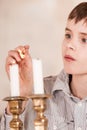 Child lighting candles with flame on match Royalty Free Stock Photo