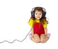 Child listens attentively to music on white Royalty Free Stock Photo