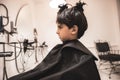 Child little boy in the barber shop hair cut professional curious portrait looking at mirror - Little boy in the barber shop hair