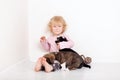 Child with little dogs playing at home. girl with puppies. baby girl kissing, hugging with puppy on white background Royalty Free Stock Photo