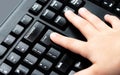 Child, little finger pressing enter key on desktop pc keyboard. Kids finger pushing enter button on computer keyboard closeup Royalty Free Stock Photo