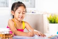 Child little girl drawing cartoon on paper before paint the color Royalty Free Stock Photo