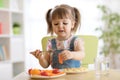 Child little girl eating healthy vegetables Royalty Free Stock Photo