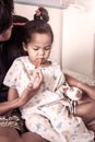 Child little girl gets medicine with a syringe in her mouth