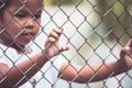 Child little girl hand holding steel mesh