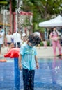 Child little girl having fun to play with water in park fountain Royalty Free Stock Photo