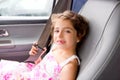 Child little girl indoor car putting safety belt