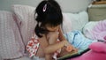 Child little girl playing game,eyes concentrate to mornitor in her bedroom.