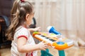 Child little girl playing on a toy piano