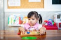 Child little girl playing wooden toys Royalty Free Stock Photo