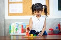 Child little girl playing wooden toys Royalty Free Stock Photo