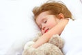 Child little girl sleeps in the bed with teddy bear Royalty Free Stock Photo