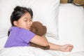 Child little girl sleeps with a toy teddy bear in the bed, rest and relax Royalty Free Stock Photo