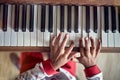 Child hands playing piano top view. Concept Christmas, New Year, holiday, family happiness, childhood