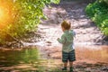 Cute little boy kid fishing in forest