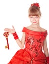 Child in long red dress holding christmas key,. Royalty Free Stock Photo