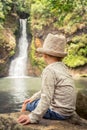 Child looking Chamouze waterfall. Mauritius