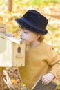 Child Looking Curious at one Birds House Royalty Free Stock Photo