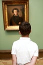 Child looking at famous portrait of Pushkin