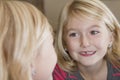 Child looking in mirror at missing front tooth