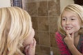 Child looking in mirror at missing front tooth Royalty Free Stock Photo