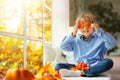 Child at window in autumn. Kids at home in fall Royalty Free Stock Photo