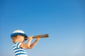 Child looking through spyglass in summer Royalty Free Stock Photo