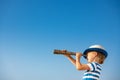 Child looking through spyglass in summer Royalty Free Stock Photo