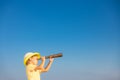 Child looking through spyglass in summer Royalty Free Stock Photo